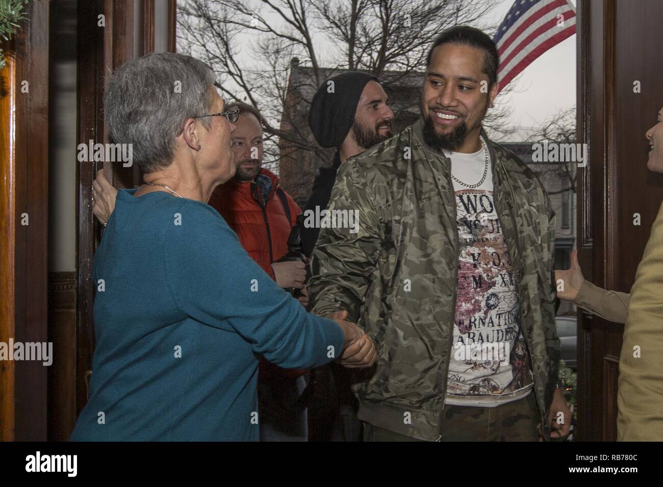 D’Arcy Neller, wife of Commandant of the Marine Corps Gen. Robert B. Neller, left,  shakes hands with Jey Uso, WWE wrestler, at the Home of the Commandants, Washington, D.C., Dec. 13, 2016. Uso and other Superstars were invited to meet with the Commandant, tour Marine Barracks Washington, and eat lunch with Marines. Stock Photo