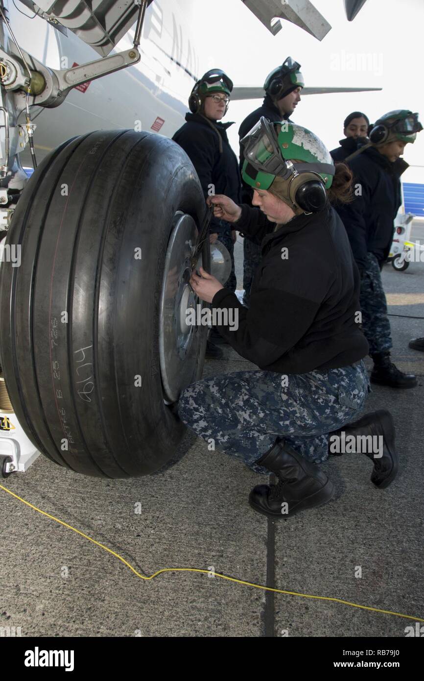 OAK HARBOR, Wash. (Dec. 15, 2016) Petty Officer 3rd Class Kamryn Taylor of Patrol Squadron (VP) 4’s Skinny Dragons changes the port outboard main landing gear  on the P-8A Poseidon aircraft on Naval Air Station (NAS) Whidbey Island’s Ault Field. VP-4 is currently in transition from the P-3 Orion, in naval service since the 1960’s, to the P-8A Poseidon and will be the first P-8 squadron on the west coast. Stock Photo