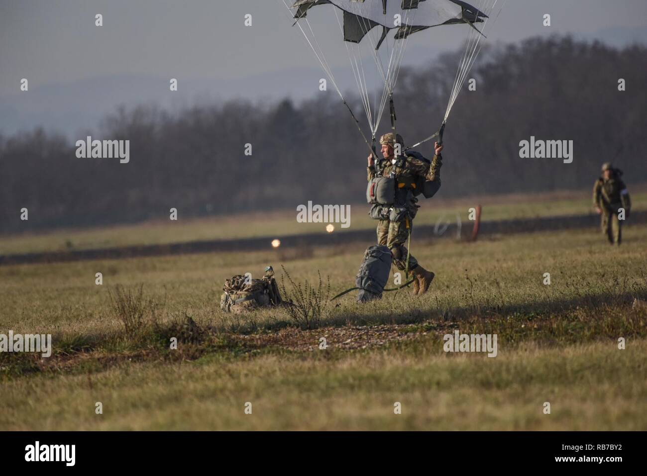 A Sky Soldier with 1st Squadron, 91st Cavalry Regiment, 173rd Airborne Brigade executes a proper parachute landing fall during an airborne operation during Exercise Mountain Shock in Cerklje, Slovenia, Dec. 1, 2016. Exercise Mountain Shock is an emergency deployment response exercise with Slovenian Armed Forces, which demonstrates the squadron’s ability to assemble and respond rapidly where needed. The 173rd Airborne Brigade is the U.S. Army Contingency Response Force in Europe, capable of projecting ready forces anywhere in the U.S. European, Africa or Central Commands' areas of responsibilit Stock Photo