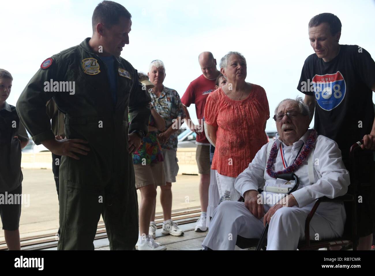 Melvin Heckman, a Pearl Harbor survivor, speaks with Cmdr. Jeffrey Bowman, the executive officer of Patrol Squadron 9, at Hangar 104 aboard Marine Corps Base Hawaii, December 2, 2016. Heckman is known for rescuing sailors from the USS Arizona during the attack on Pearl Harbor after the ship was attacked by Japanese Zeros. 'I reached out to grab a man's hand to help him up and take him to the island,' said Heckman, a Sheridan, Wyoming, native. 'I got him out of the water and saw that everything below his belly button was missing; he died in my arms'  Heckman was awarded a purple heart for his b Stock Photo