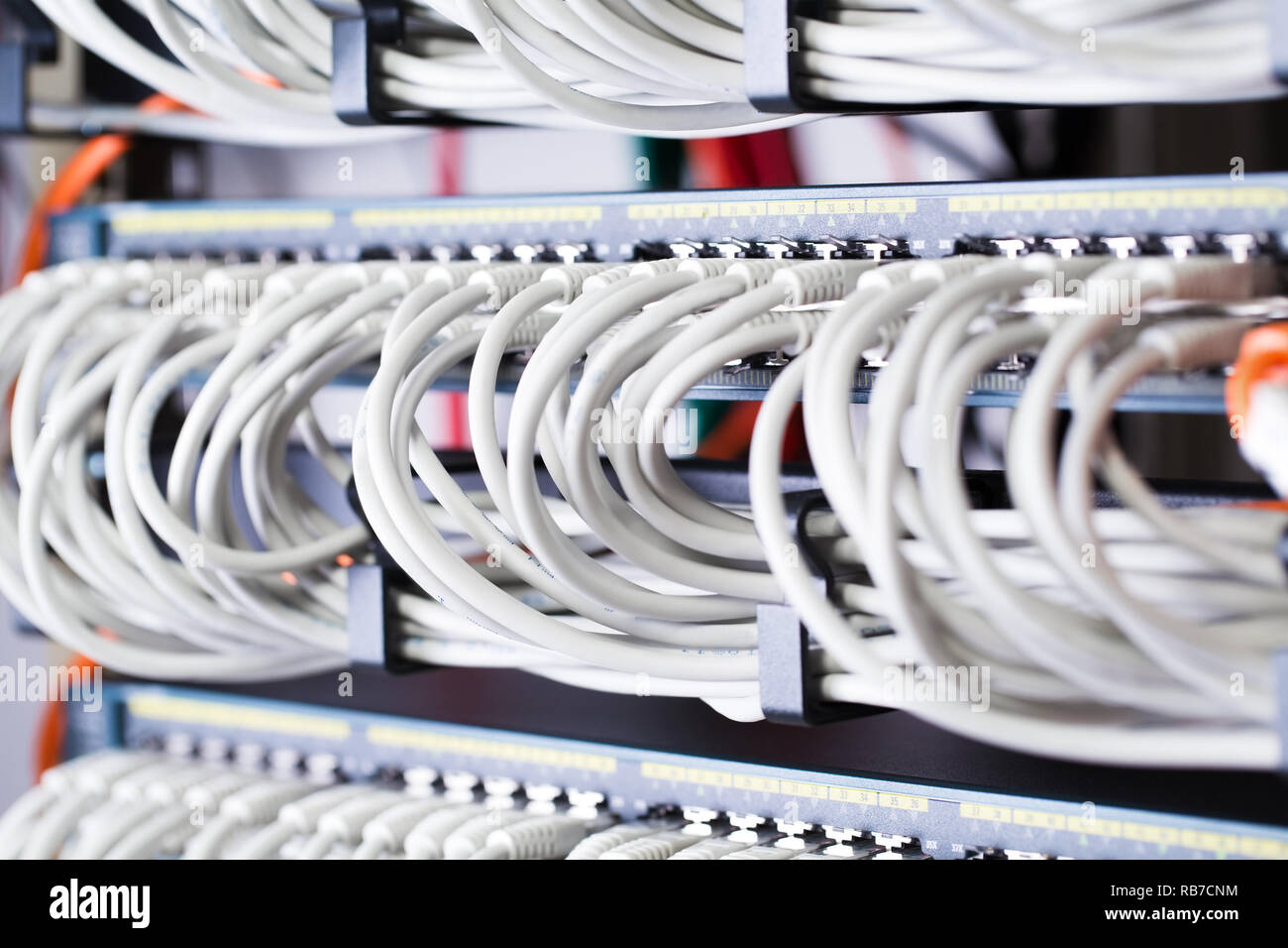 Gigabit network switch and perfect aligned patch cables in datacenter Stock Photo