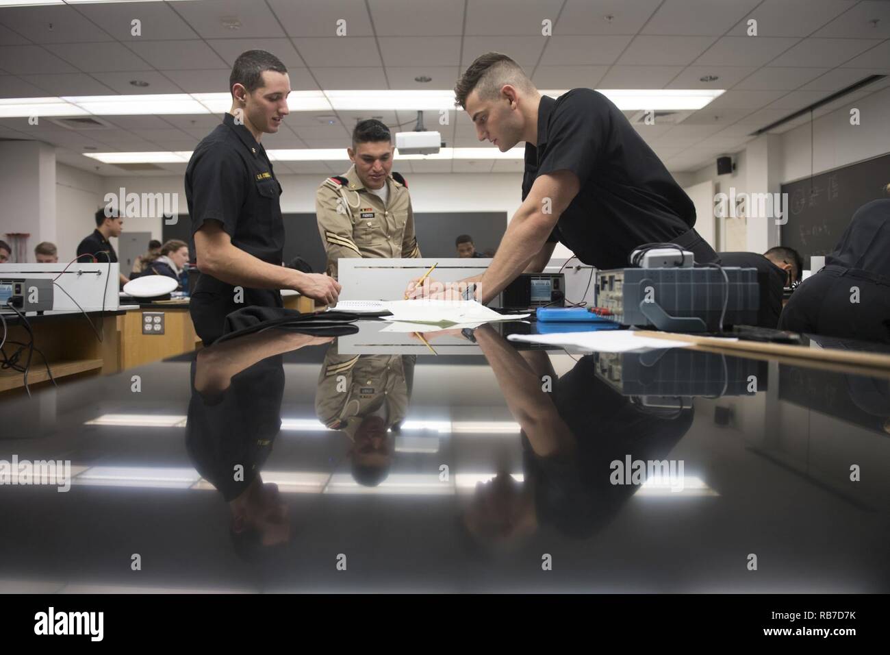 ANNAPOLIS, Md. (Dec. 02, 2016)  United States Naval Academy (USNA) Midshipman 3rd Class Cody Mendelow, Midshipman 3rd Class Gavin O’Donnell and Mexican Cadet Ricardo Fuentes work together to solve a physics equation. Cadets from Mexico's Military Academy, Heroico Colegio Militar, are visiting USNA to play an exhibition American-style football game with the USNA Sprint Football team. Stock Photo