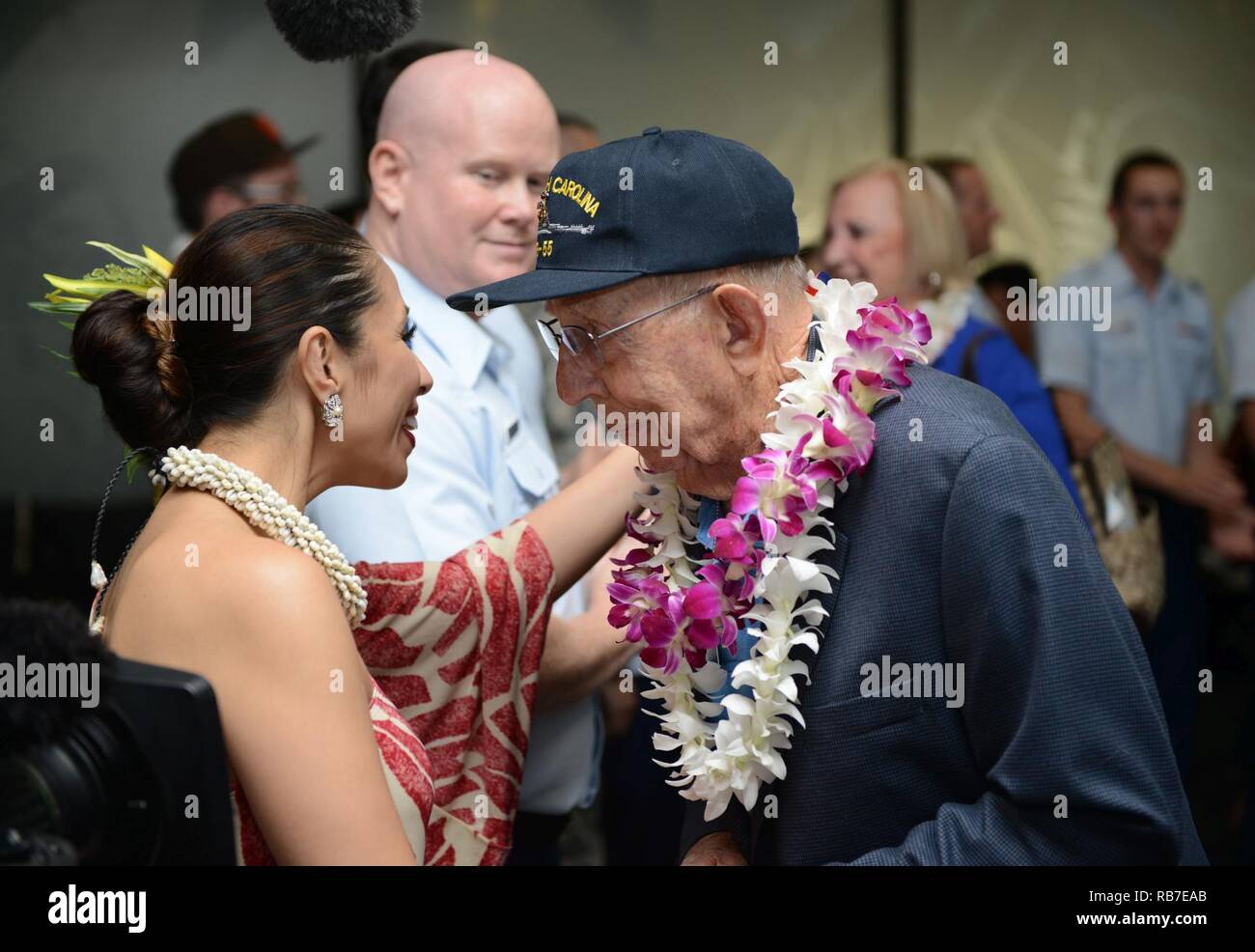 a world war ii veteran shakes hands with personnel and military