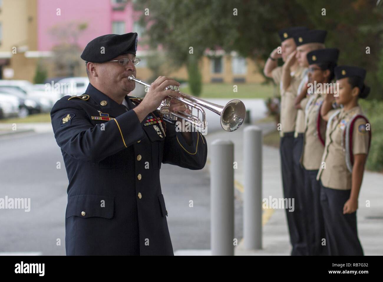 After a 21-gun salute, Spc. Matthew Rodriguez, bugler, 3rd Infantry Division Band plays taps honoring the fallen veterans during a remembrance ceremony at the National Museum of the Mighty Eighth Air Force in Pooler, Georgia December 4. U.S. Army Stock Photo