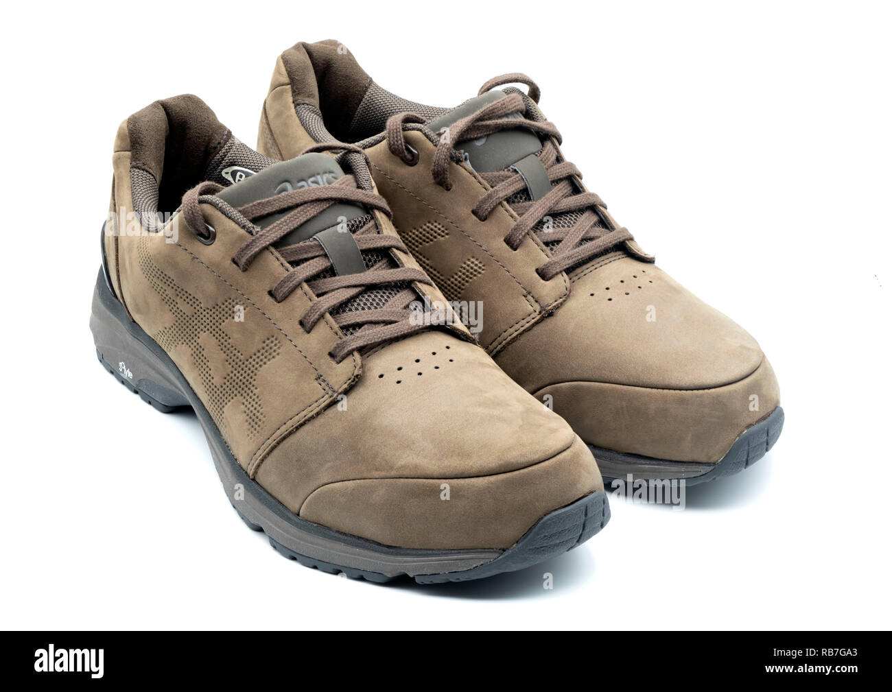One pair of Asics brown leather shoes isolated on white background Stock  Photo - Alamy