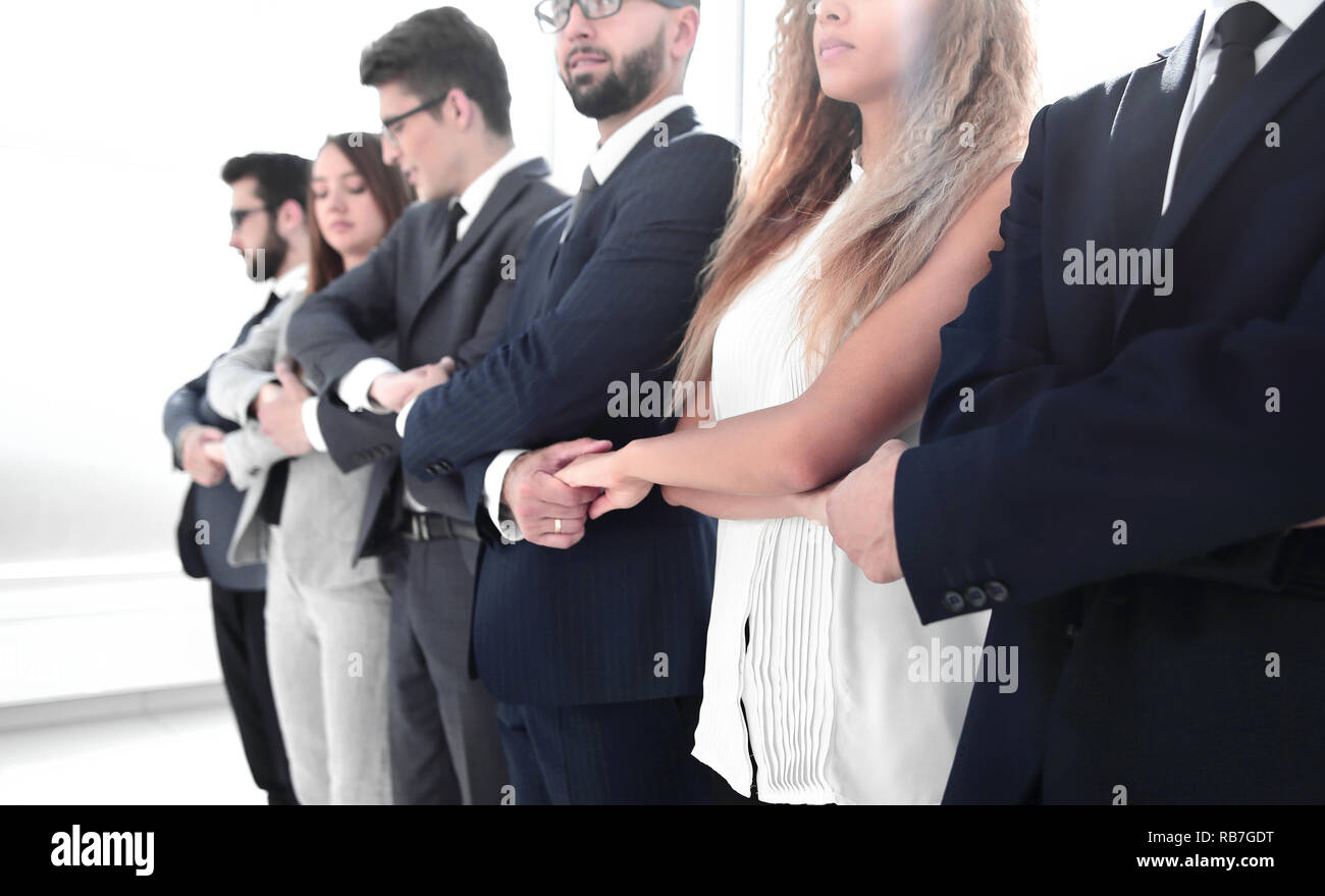 close up.serious business team standing together Stock Photo - Alamy
