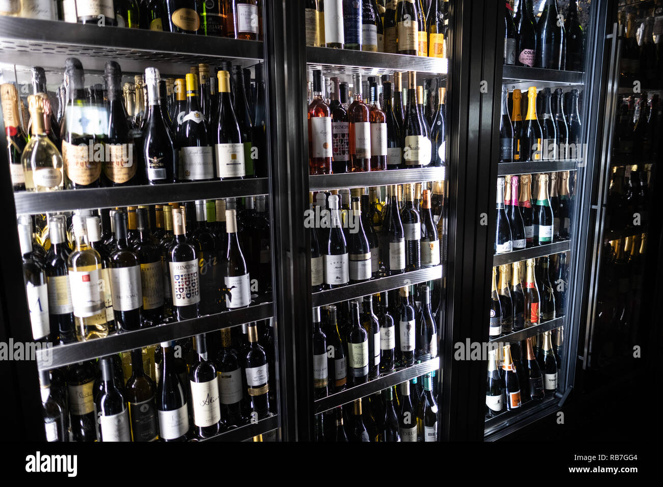Wine bottles in large cooler fridge at a restaurant Stock Photo