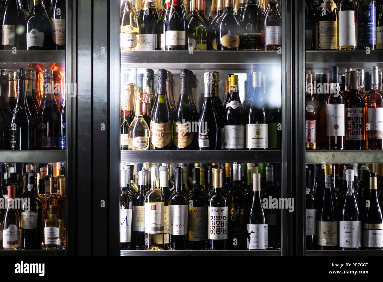 Wine bottles in large cooler fridge at a restaurant Stock Photo