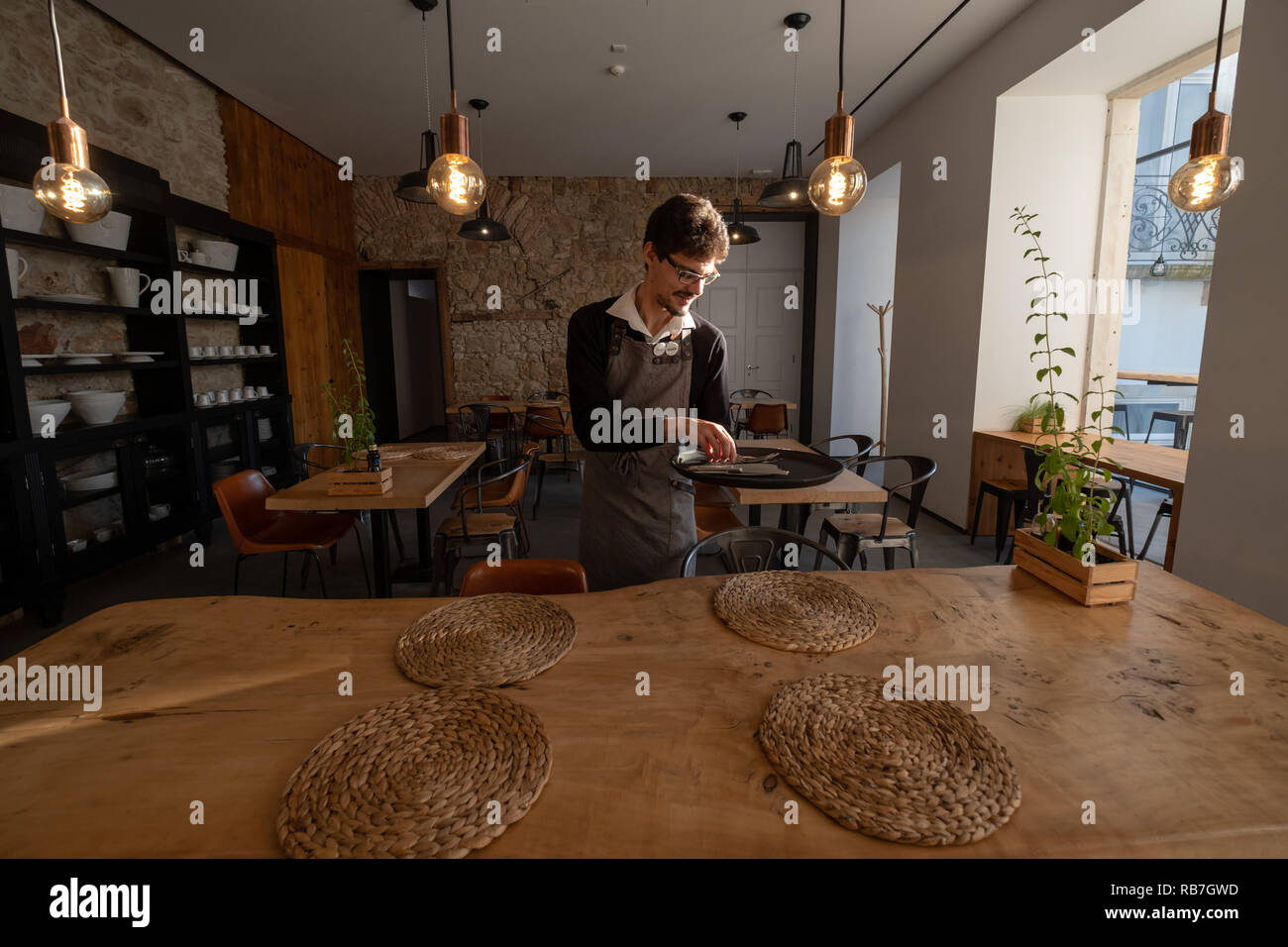 Waiter setting the table at the Sapientia Boutique Hotel in Coimbra, Portugal, Europe Stock Photo