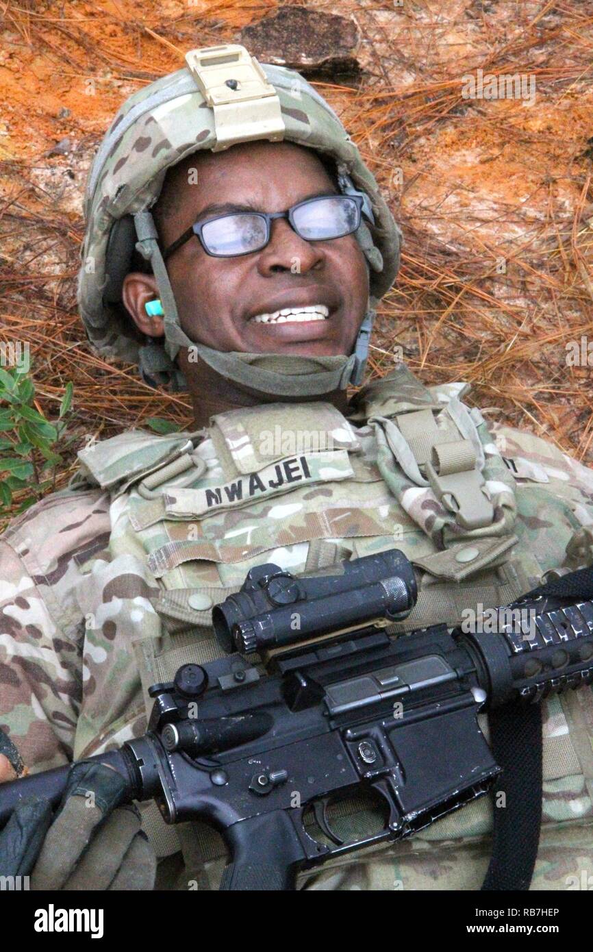 Pfc. Anthony Nwajei, a combat medic with 5th Squadron, 7th Cavalry Regiment, 1st Armored Brigade Combat Team, 3rd Infantry Division holds his feet six inches off the ground while flutter-kicking Dec. 5, 2016 at Fort Stewart, Georgia during the stress shoot for the Squadron's Spur Ride. Stock Photo