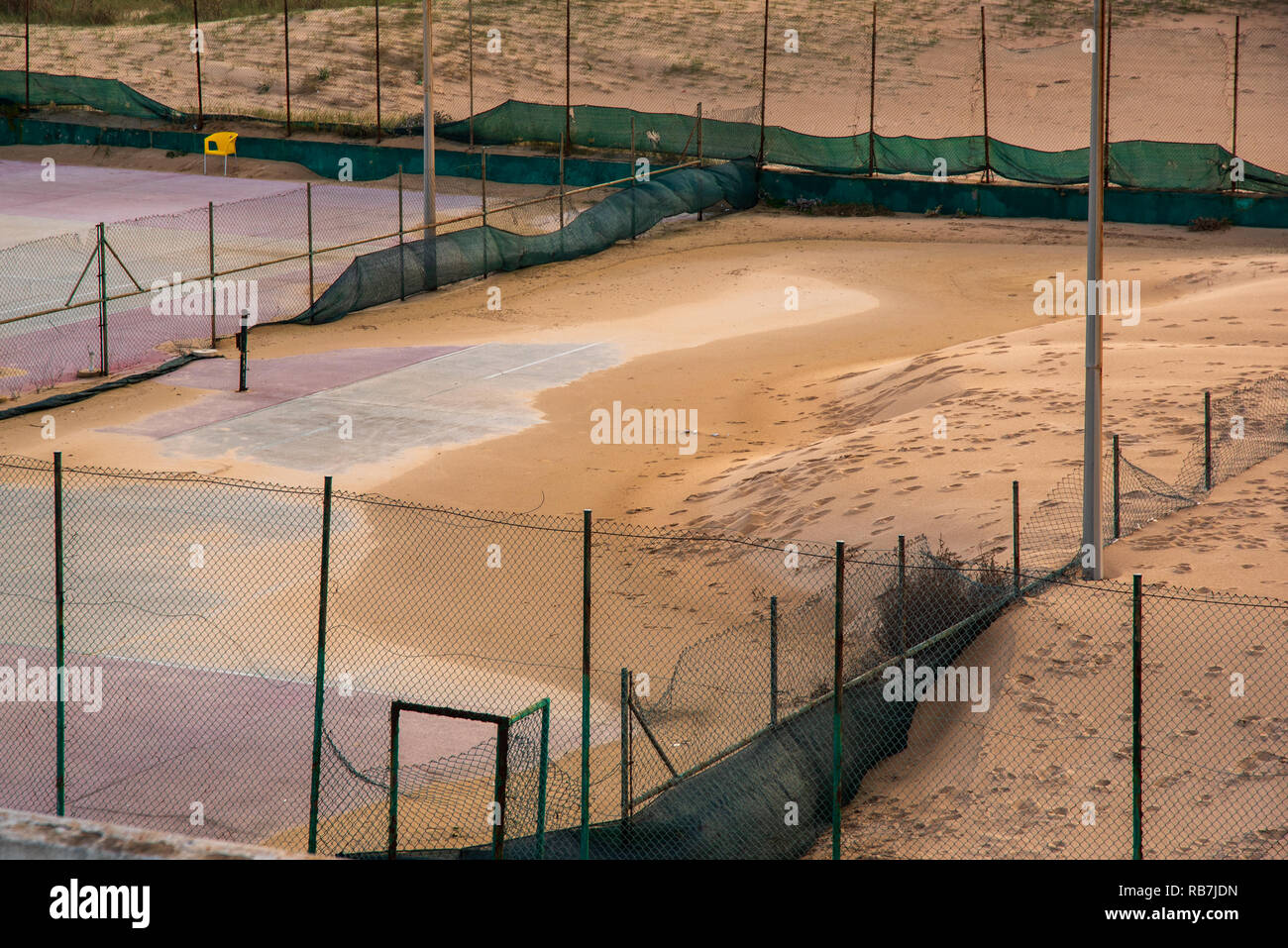 abandoned tennis court full of sand in a beach in Portugal Stock Photo -  Alamy