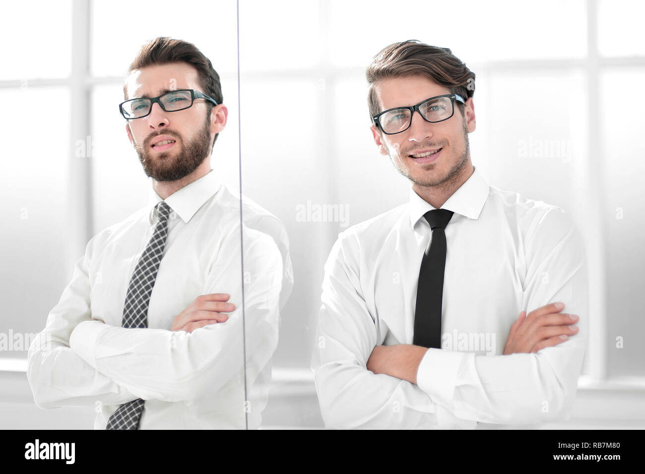 two serious business people standing in the office Stock Photo - Alamy