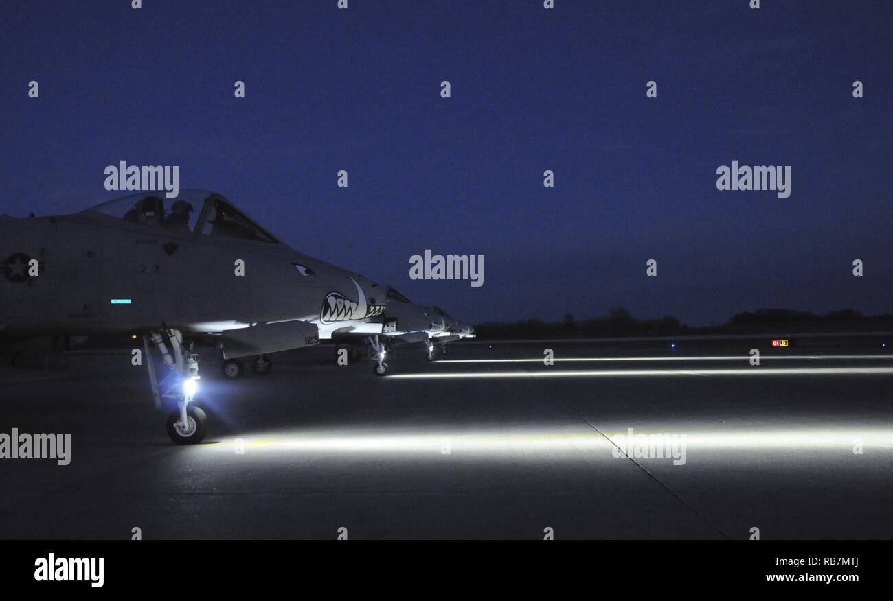 Four A-10 Thunderbolt IIs prepare to take-off from Whiteman Air Force Base, Missouri, Dec. 6, 2016. Four 303rd Fighter Squadron pilots conducted night close-air-support training with 14th Air Support Operations Squadron joint terminal attack controllers from Pope Army Airfield, N.C. Stock Photo