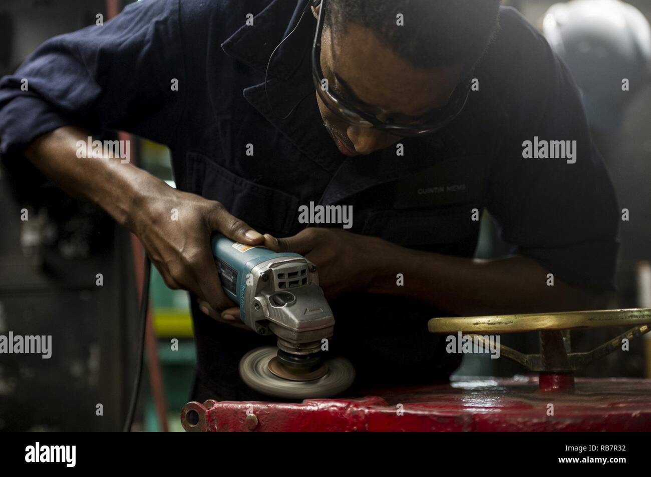 ATLANTIC OCEAN (Dec. 7, 2016) Seaman Quintin Mems, from Flint, Michigan, sands down a hatch