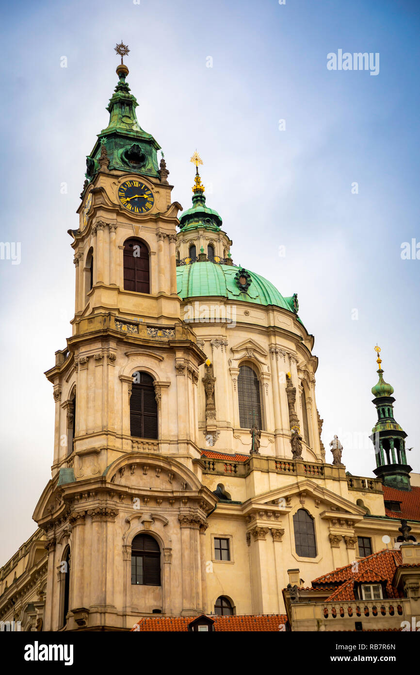 Church of Saint Nicolas or kostel svateho Mikulase, view from mostecka street with people in Prague, Czech Republic Stock Photo