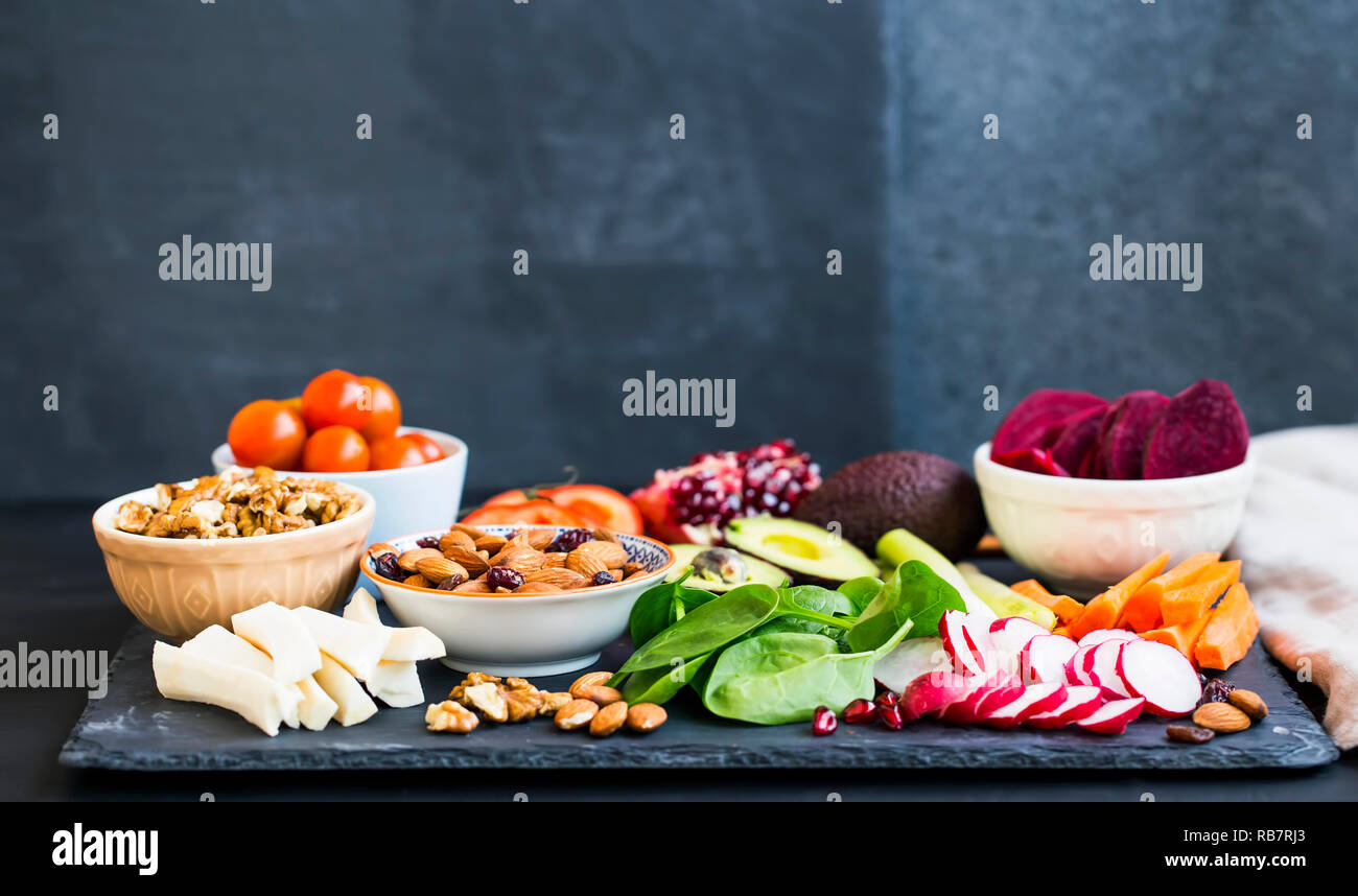 Healthy meal selection of clean organic foods: vegetables, nuts, avocado, almonds, green leaves, beet Stock Photo