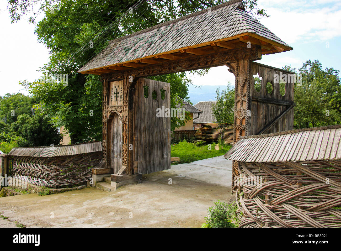 Traditional carved wooden gate in the old vilage Sighetu Marmatiei,Maramures, Romania. Stock Photo