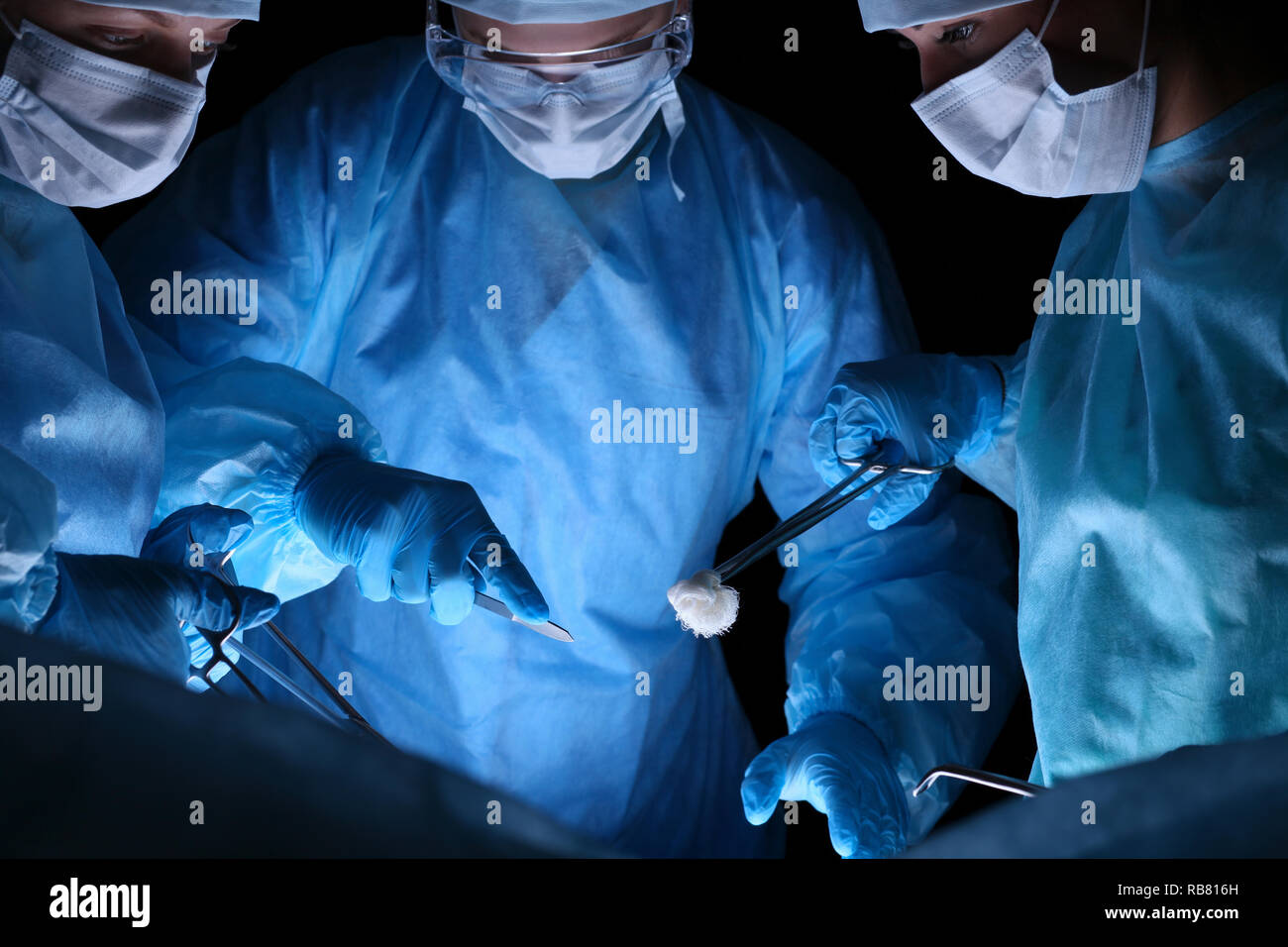 Group of surgeons in masks performing operation. Medicine, surgery and ...