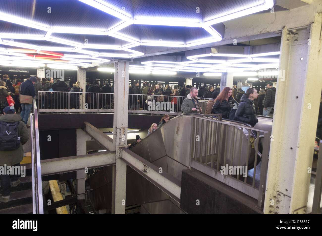 Subway train riders ride the escalator that connects the F train Broadway Lafayette Station with the Bleeker Street No. 6 train station  in Manhattan. Stock Photo