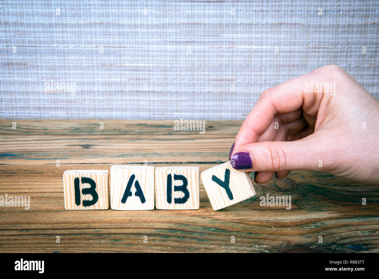 baby. Wooden letters on the office desk Stock Photo Alamy