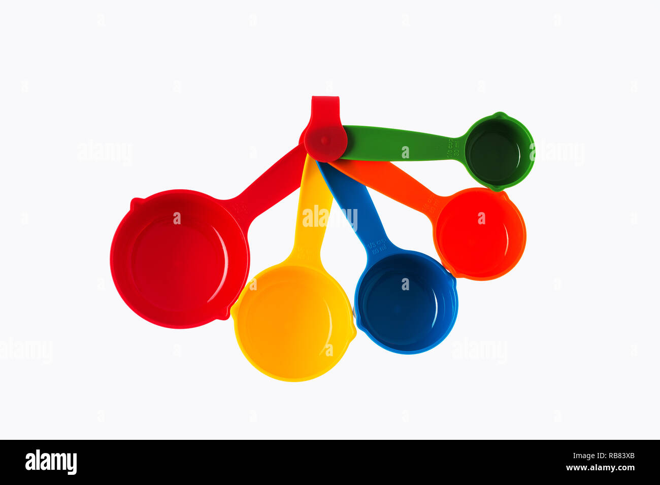 Color plastic dosing spoons isolated on a white background. Stock Photo
