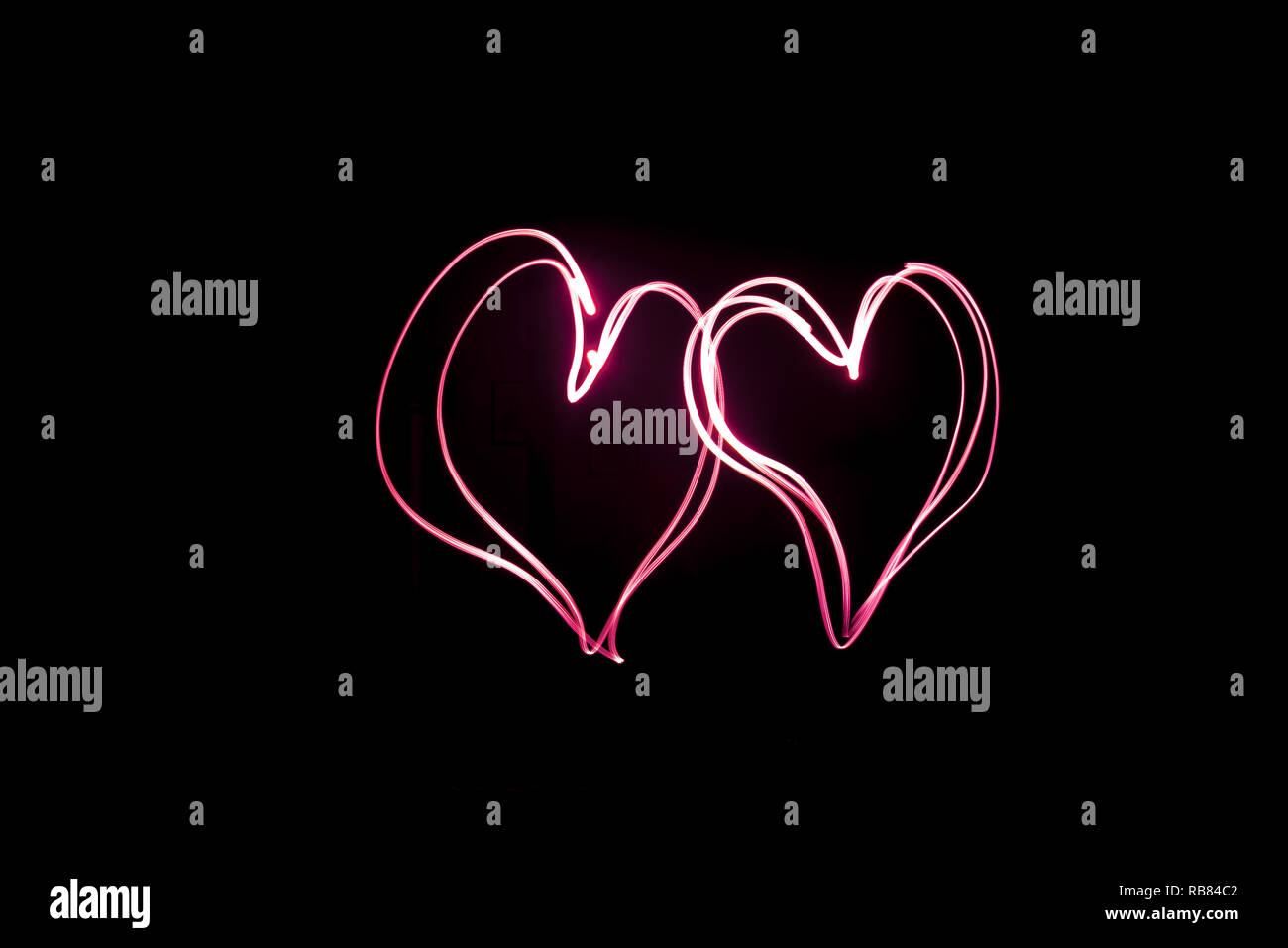 Light Painting, Two red hearts, long exposure Stock Photo