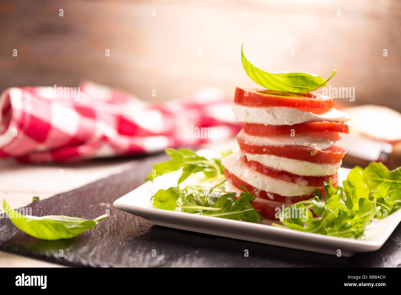 Tomato and Mozzarella slices with basil leaves Stock Photo - Alamy