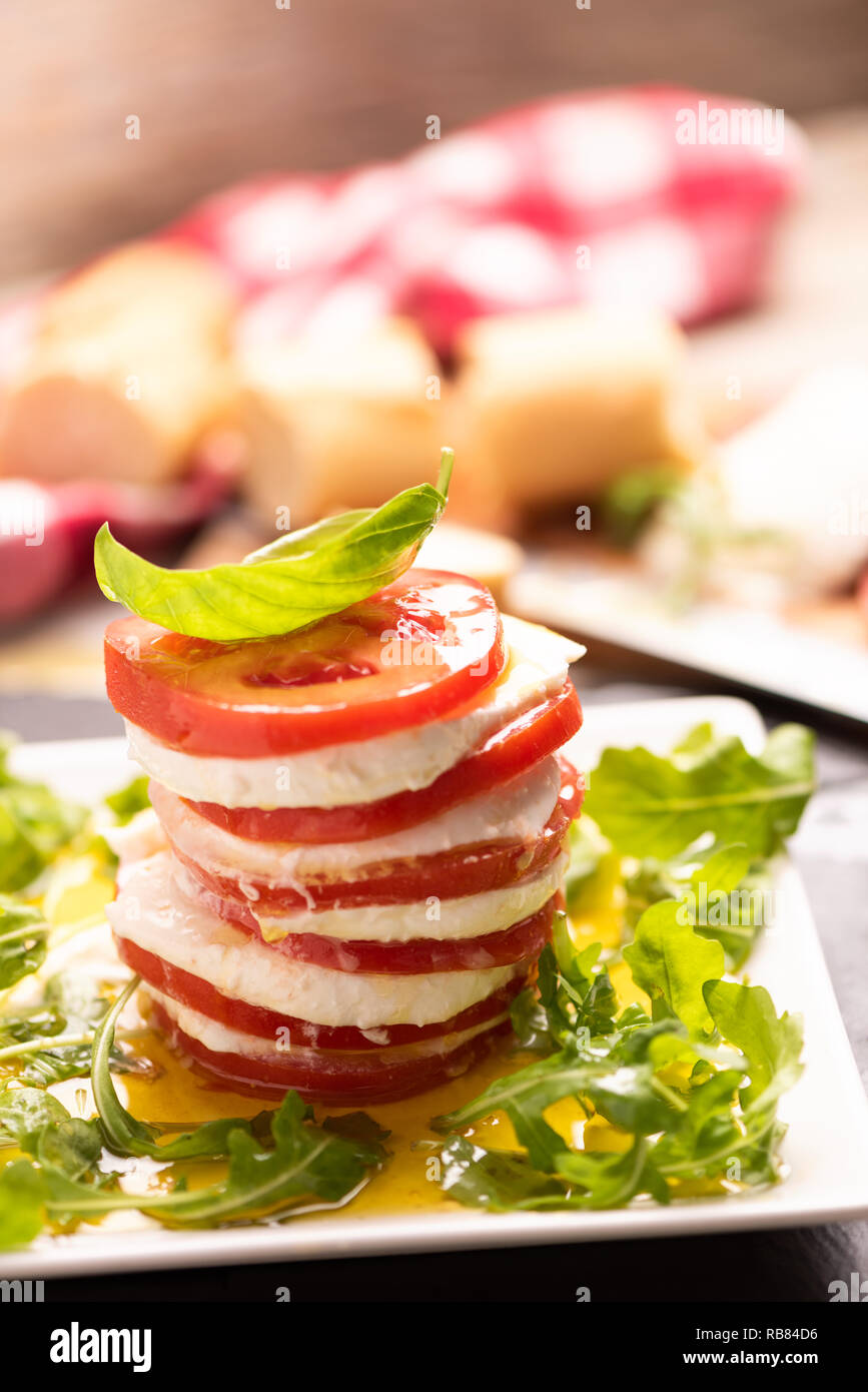 Tomato and Mozzarella slices with basil leaves Stock Photo - Alamy