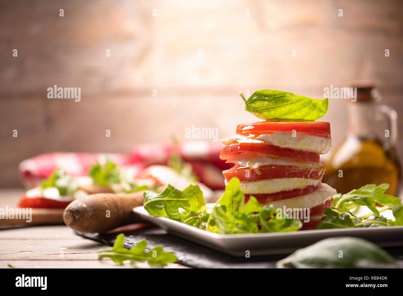 Tomato and Mozzarella slices with basil leaves Stock Photo - Alamy