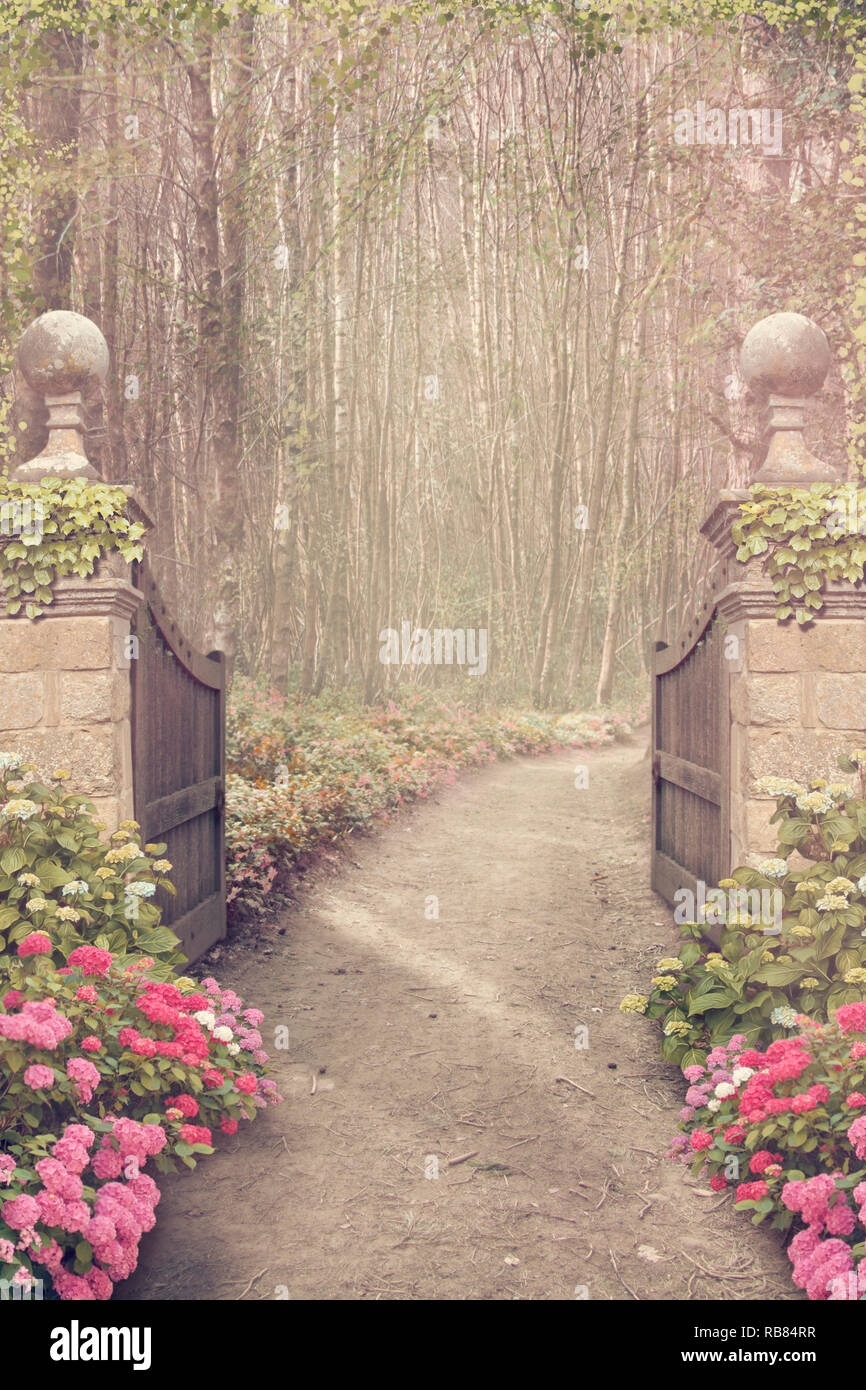 Fantasy garden with gates and woodland background Stock Photo