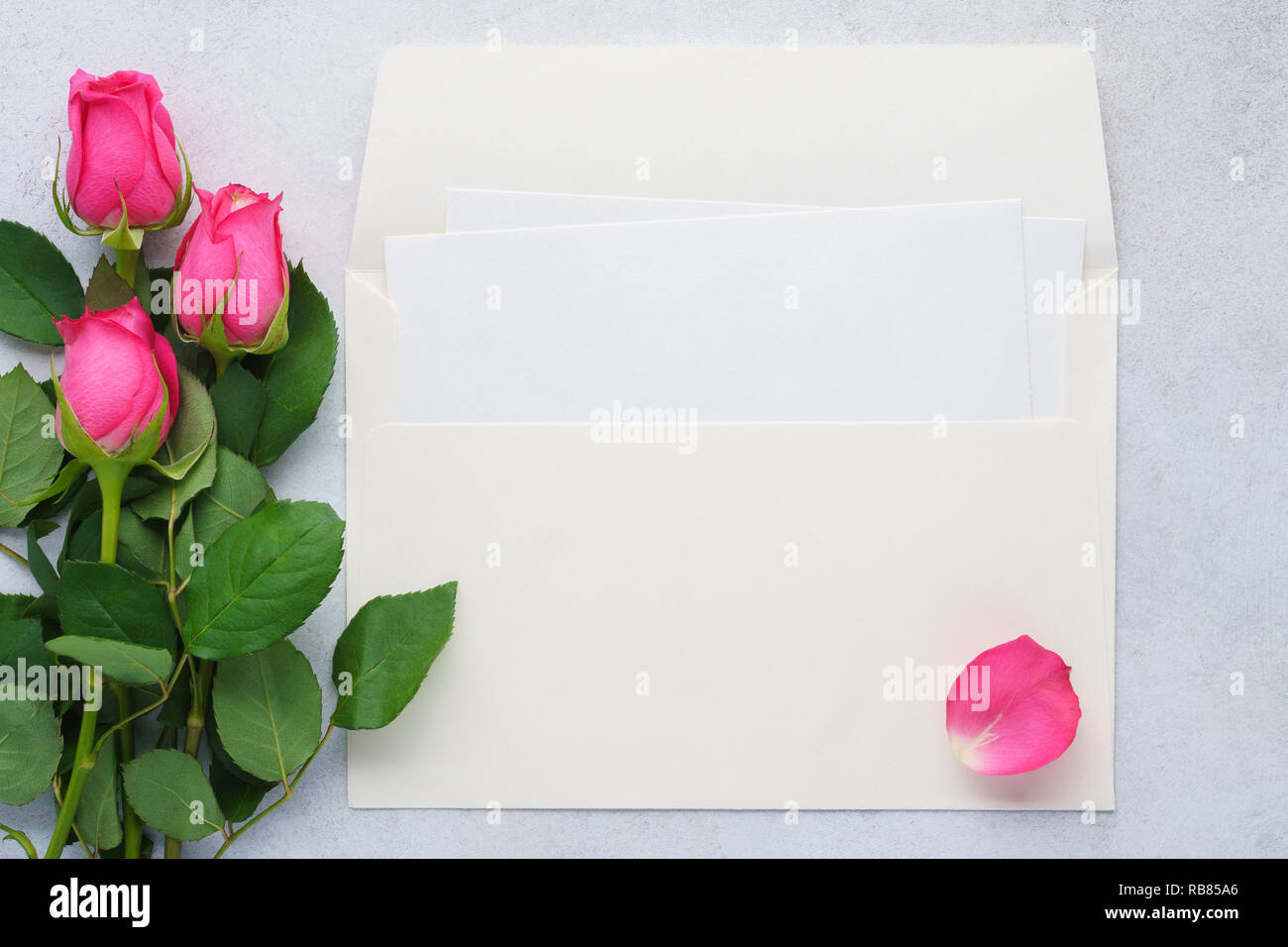 blank list of paper, envelope and pink roses. love letter or