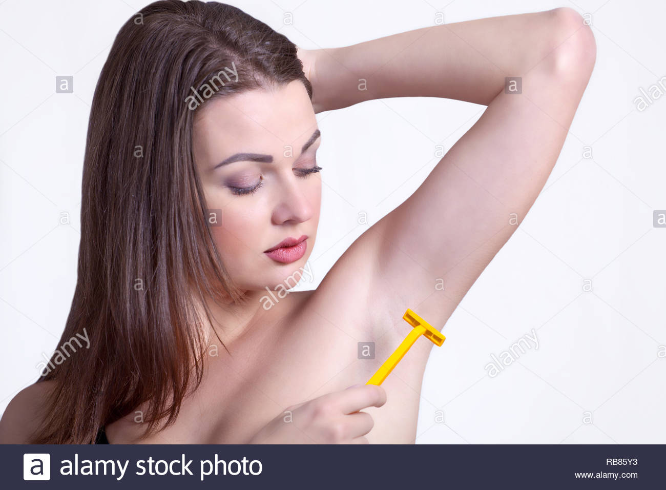 Girl armpit shave, epilation or depilation, holding razor with ...