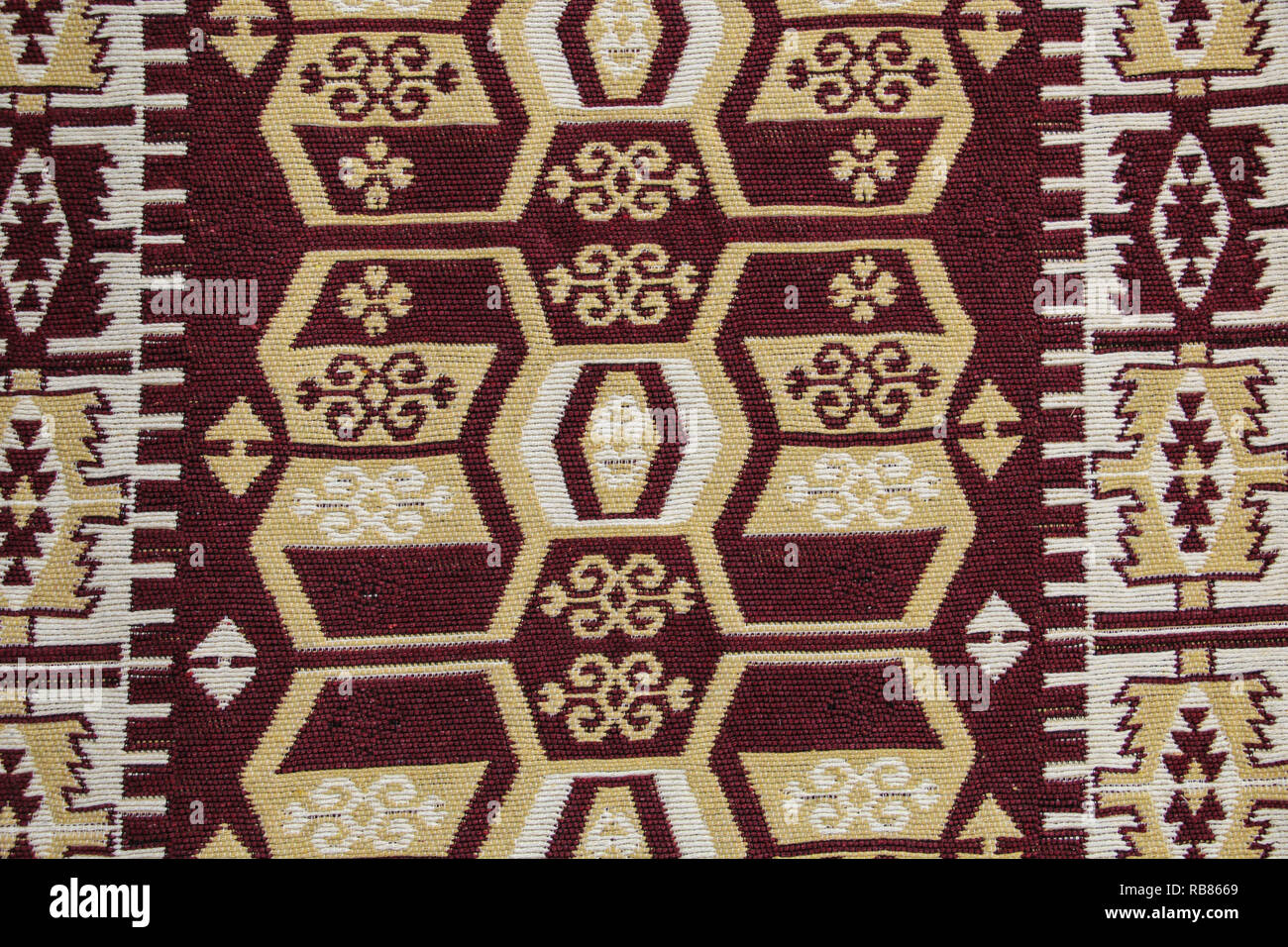 Old traditional Jordan carpet with a geometric pattern in dark red