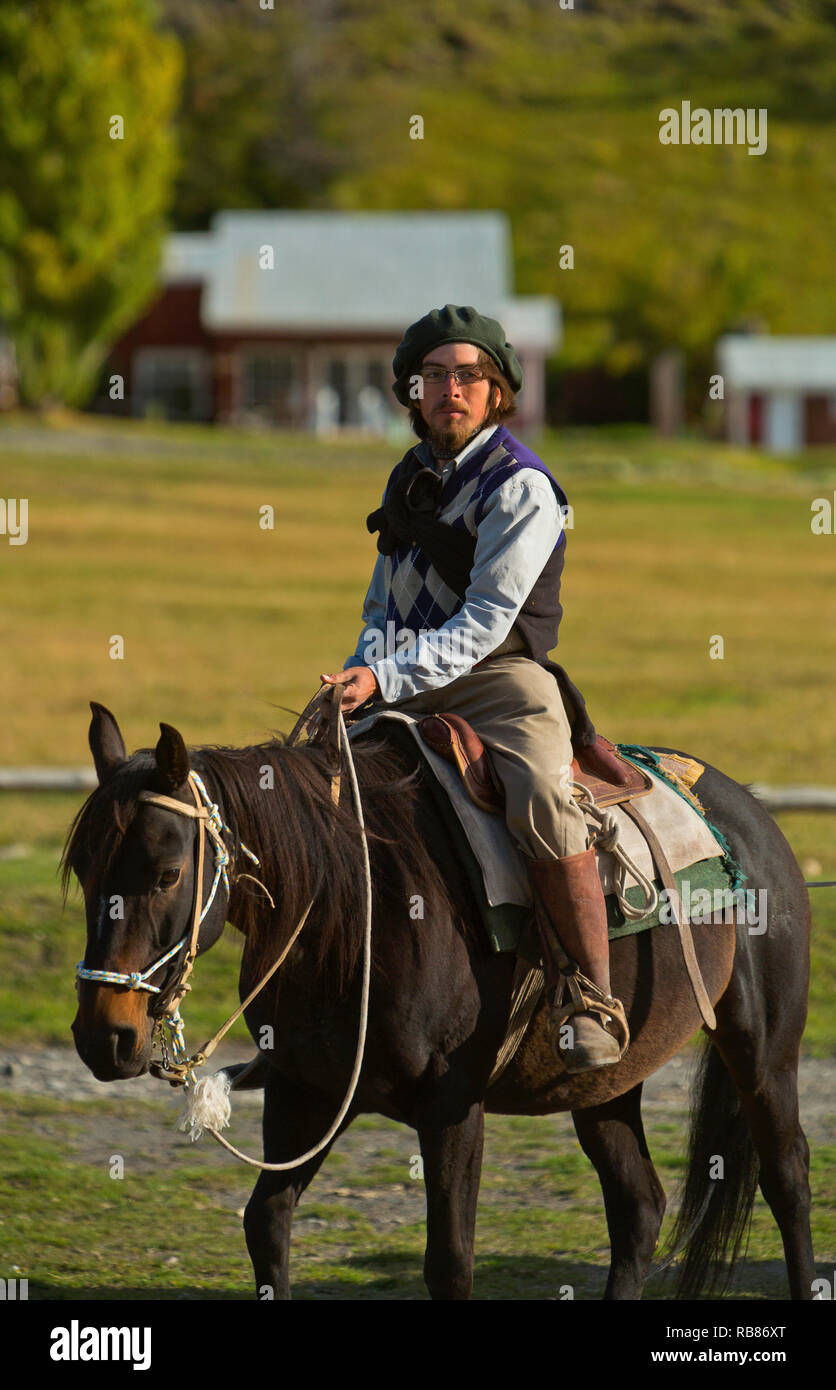 A gaucho horseback riding in Torres del Paine National Park in the Andes Mountains of Chile. Stock Photo