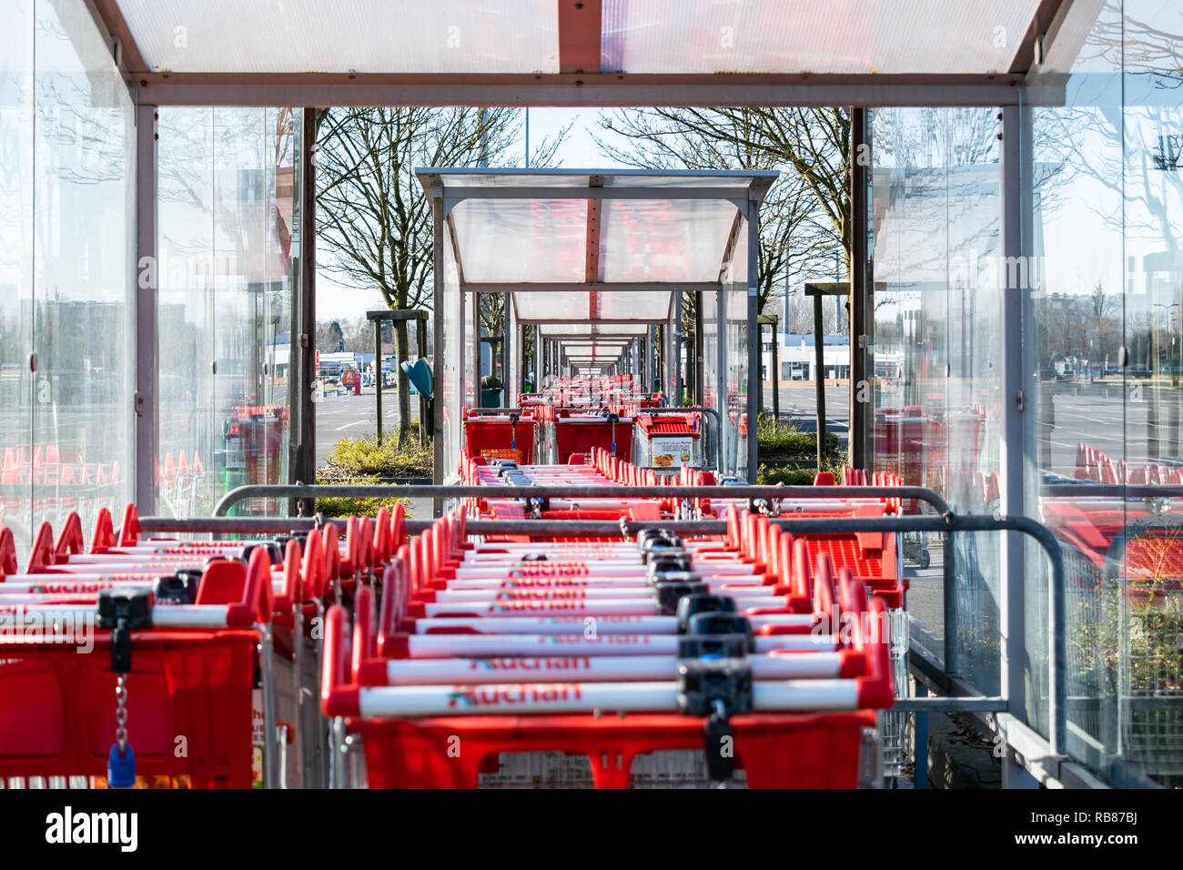 Roncq,FRANCE-February 25,2018: Close-up shopping trolleys Auchan hypermarket.Auchan is a French international supermarket chain. Stock Photo