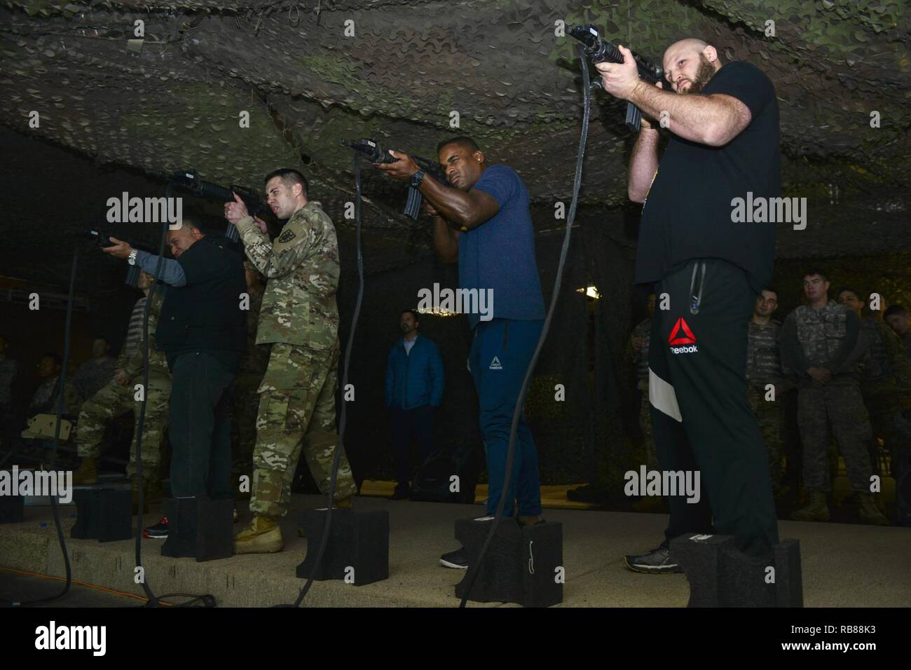 U.S. Army Soldiers operate Engagement Skills Trainer weapons with Brian  Garcia, left, MMAjunkie radio host, Lorenz Larkin, center, UFC welterweight  fighter, and Ben Rothwell, right, UFC heavyweight fighter, at Joint Base  Langley-Eustis,