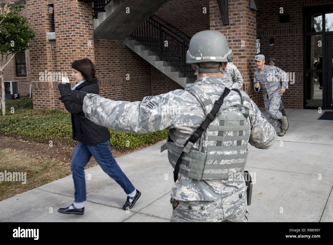A member of the 23d Security Forces Squadron directs people away from ...