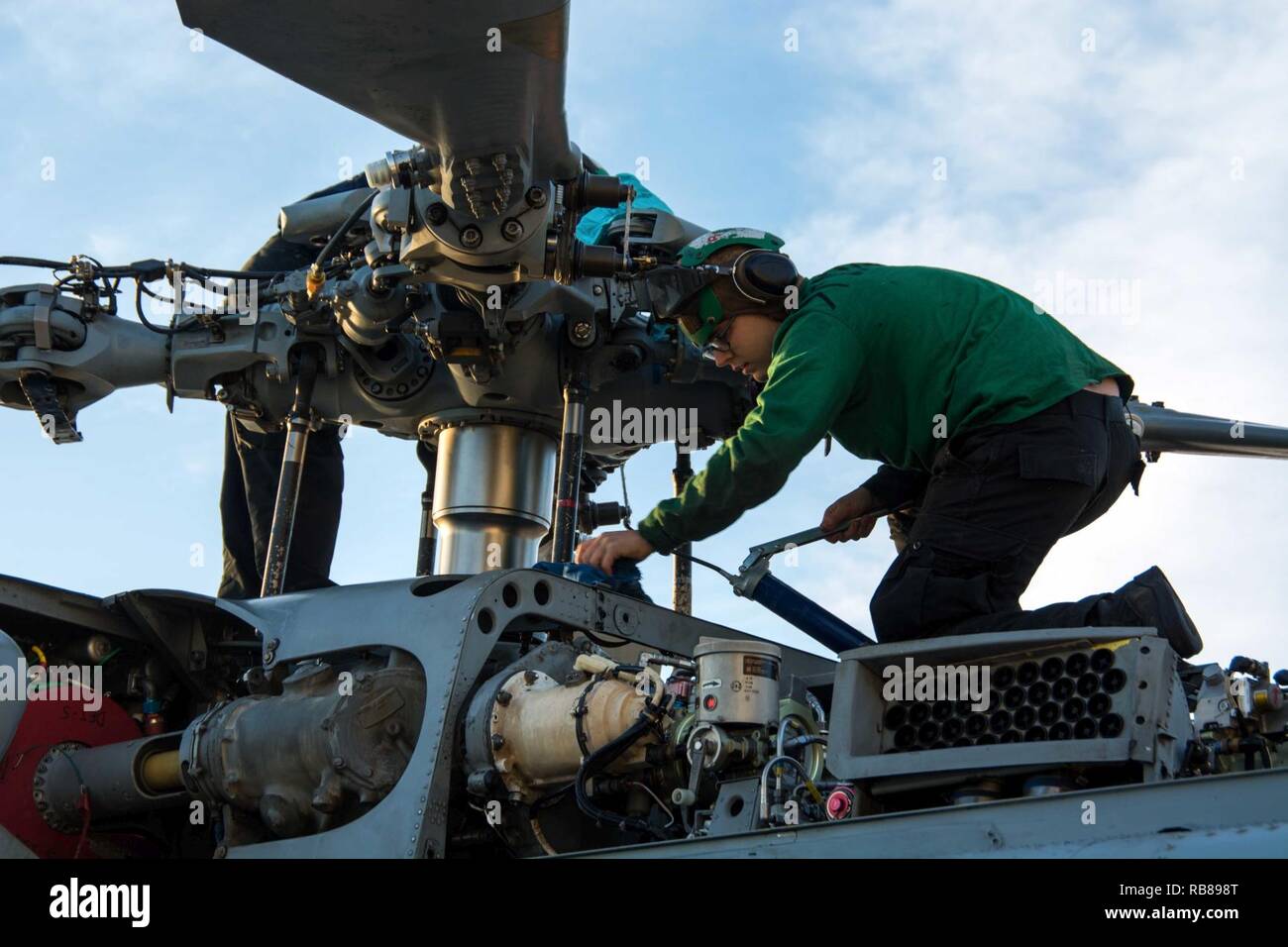ROTA, Spain (Dec. 8, 2016) Petty Officer 3rd Class Justin Springer, from  Jacksonville, Fla., performs maintenance on an MH-60R Sea Hawk helicopter  of the Swamp Foxes of Helicopter Maritime Strike Squadron (HSM)