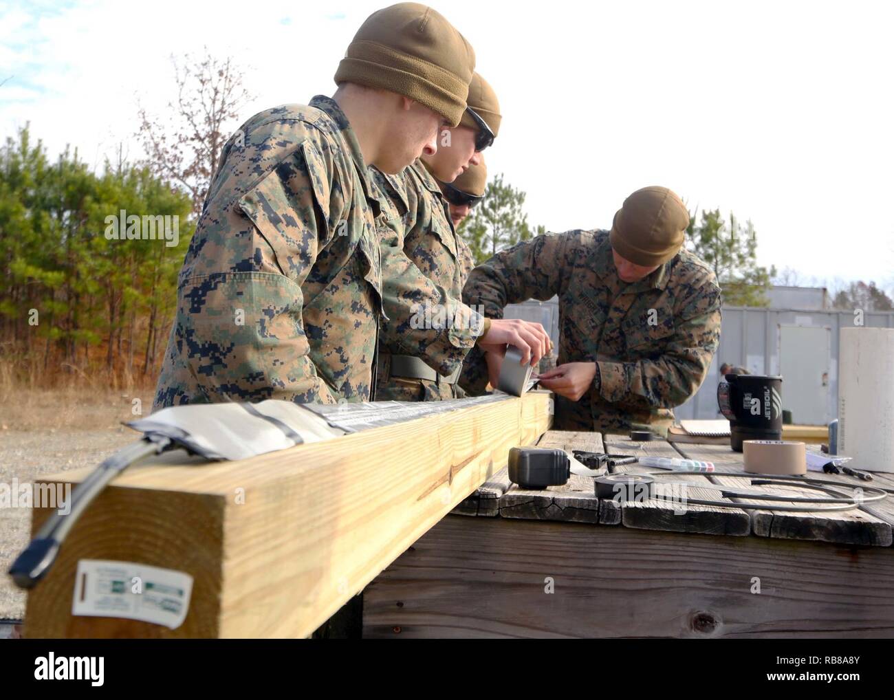 Marines craft together a detonation cord linear charge for an urban