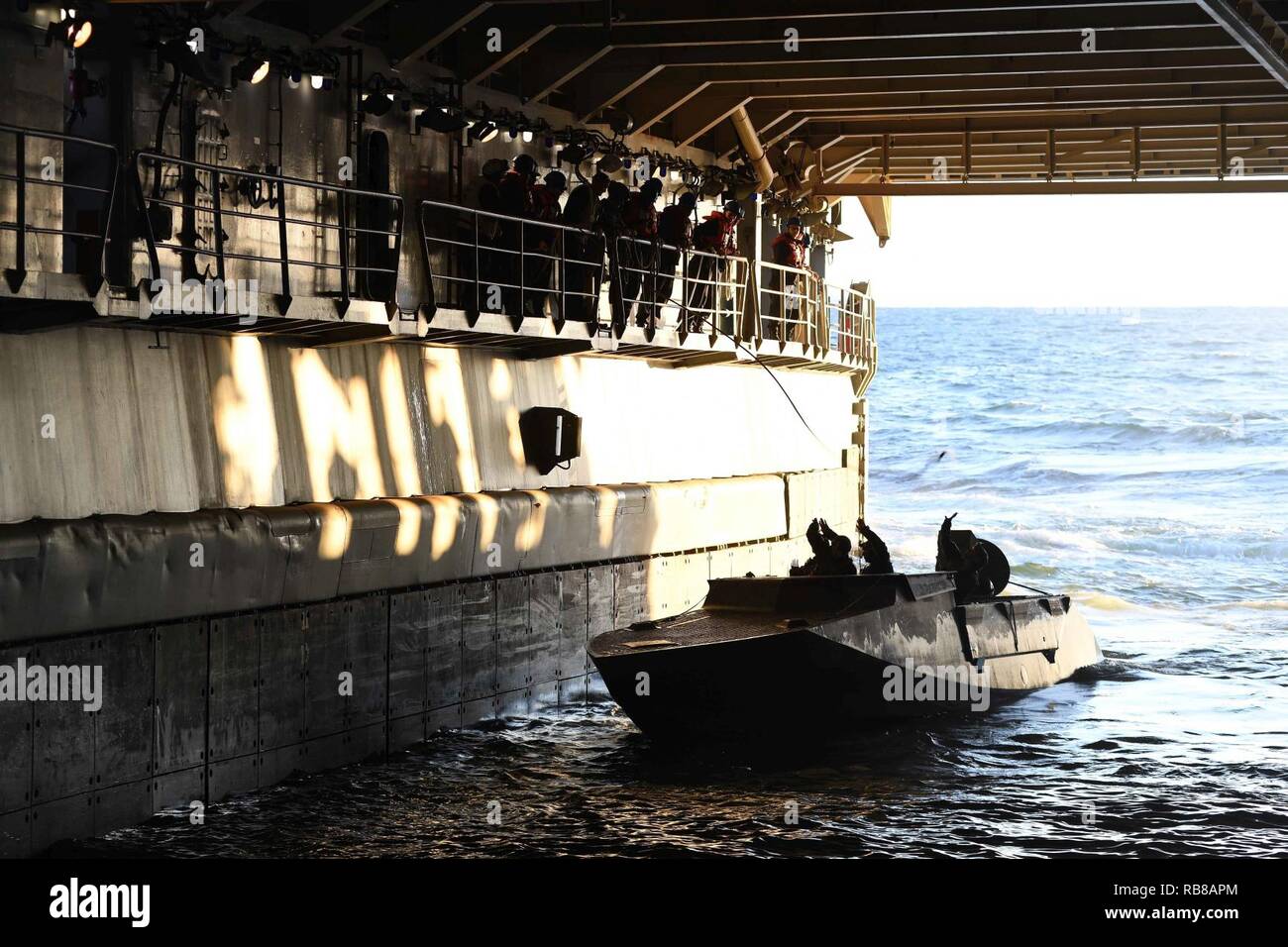 ATLANTIC OCEAN (Dec. 09, 2016) – Sailors aboard the amphibious dock landing ship USS Carter Hall (LSD 50) throw line to Special Warfare Combatant-craft Crewmen (SWCC) with Special Boat Team (SBT) 20 during a training exercise in the ship’s well deck. The team practiced mooring and maneuvering their craft inside the ship’s well deck. Carter Hall is underway with the Bataan Amphibious Readiness Group (ARG) participating in ARG/Marine Expeditionary Unit Exercise (ARG/MEUEX). Stock Photo