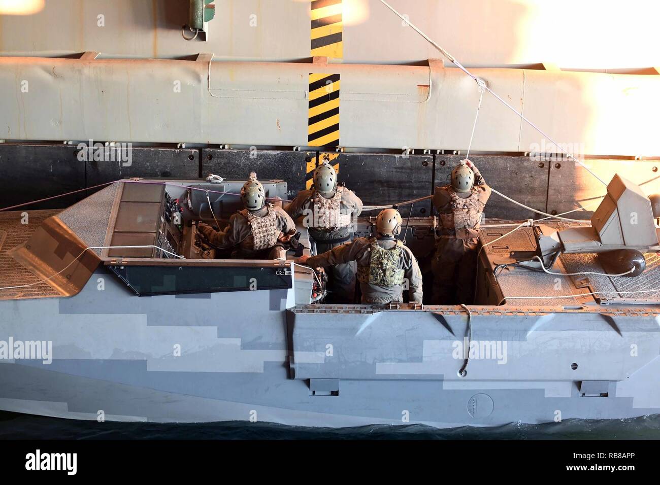 ATLANTIC OCEAN (Dec. 09, 2016) – Special Warfare Combatant-craft Crewmen (SWCC) with Special Boat Team (SBT) 20 secure lines in the well deck aboard the amphibious dock landing ship USS Carter Hall (LSD 50). The team practiced mooring and maneuvering their craft inside the ship’s well deck. Carter Hall is underway with the Bataan Amphibious Readiness Group (ARG) participating in ARG/Marine Expeditionary Unit Exercise (ARG/MEUEX). Stock Photo