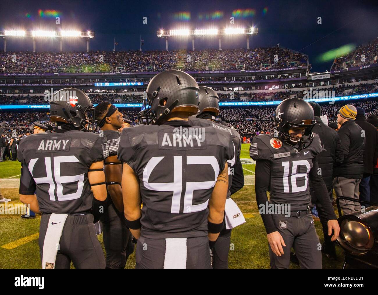 Cadets from the Army West Point football team prepare on the sideline
