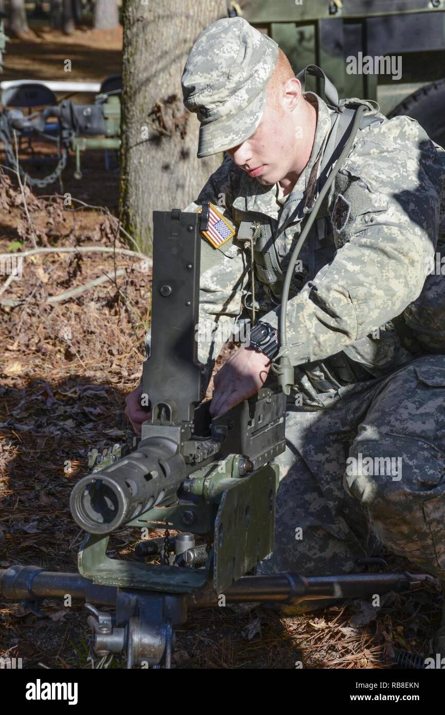 Louisiana National Guard's Spc. Dylan Cassel with A Troop, 2nd Squadron, 108th Cavalry Regiment, 256th Infantry Brigade Combat Team disassembles a .50-caliber machine gun during the annual Spur Ride at Camp Minden in Minden, Louisiana, Dec. 10, 2016. Soldiers drew two weapons from a box that they would have to reassemble and perform a functions check on those weapons in an allotted amount of time. Stock Photo