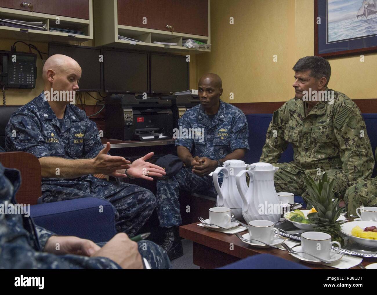 CHANGI, Singapore (Dec. 13, 2016) Vice Chief of Naval Operations Adm. William Moran speaks with Cmdr. Scott Larson, commanding officer, USS Coronado (LCS 4), left, and Capt. Lex Walker, deputy commodore, Destroyer Squadron 7, center, prior to a tour aboard Coronado. Currently on a rotational deployment in support of the Asia-Pacific Rebalance, Coronado is a fast and agile warship tailor-made to patrol the region's littorals and work hull-to-hull with partner navies, providing 7th Fleet with the flexible capabilities it needs now and in the future. Stock Photo