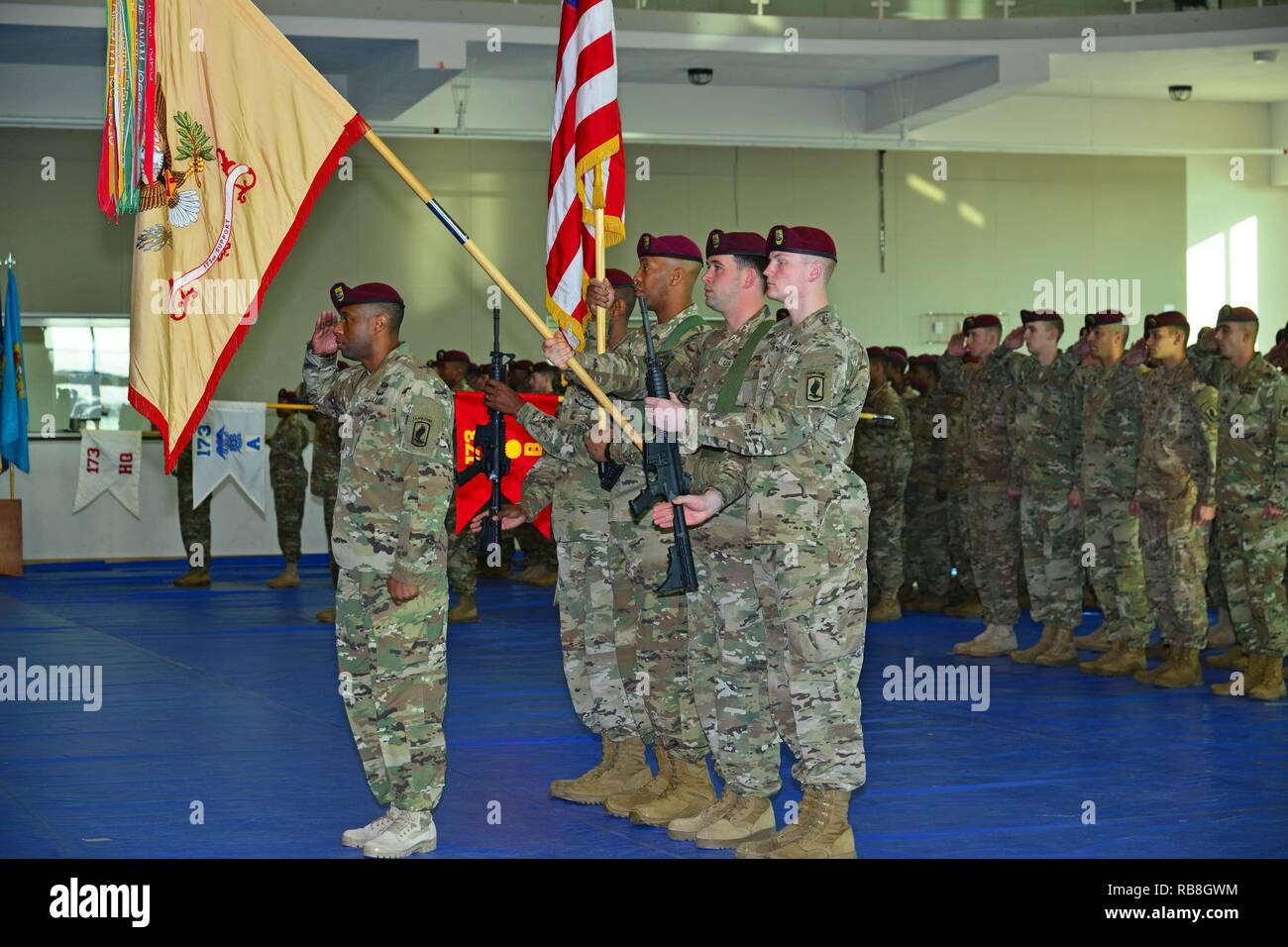 Sgt. 1st Class Dwayne T. Cottoner, 173rd Brigade Support Battalion,173rd Airborne Brigade, renders honors to the Italian and U.S. national anthems during a change of responsibility ceremony at Caserma Del Din in Vicenza, Italy, Dec. 13, 2016.  The 173rd Airborne Brigade based in Vicenza, Italy, is the Army Contingency Response Force in Europe, and is capable of projecting forces to conduct the full of range of military operations across the United State European, Central and Africa Commands areas of responsibility. Stock Photo