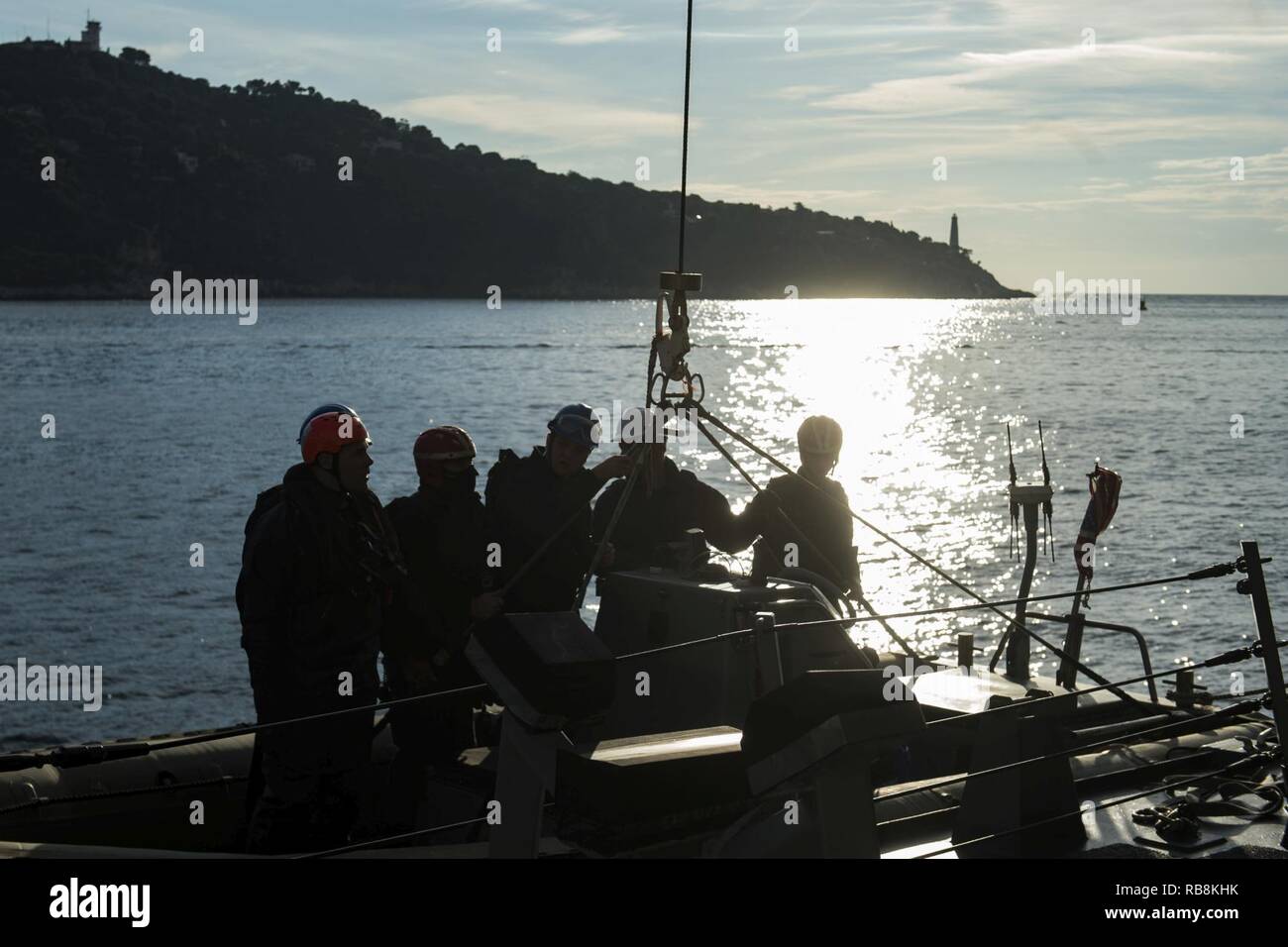 VILLEFRANCHE, France (Dec. 16, 2016) Sailors assigned to the guided-missile destroyer USS Nitze man a rigid hull inflatable boat before mooring to a buey. Nitze, deployed as part of the Eisenhower Carrier Strike Group, is conducting naval operations in the U.S. 6th Fleet area of operations in support of U.S. national security interests in Europe. Stock Photo