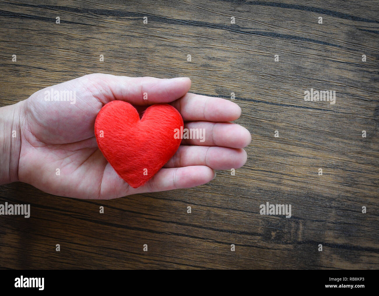 Give Love Man holding red Heart in hands for love Valentines day