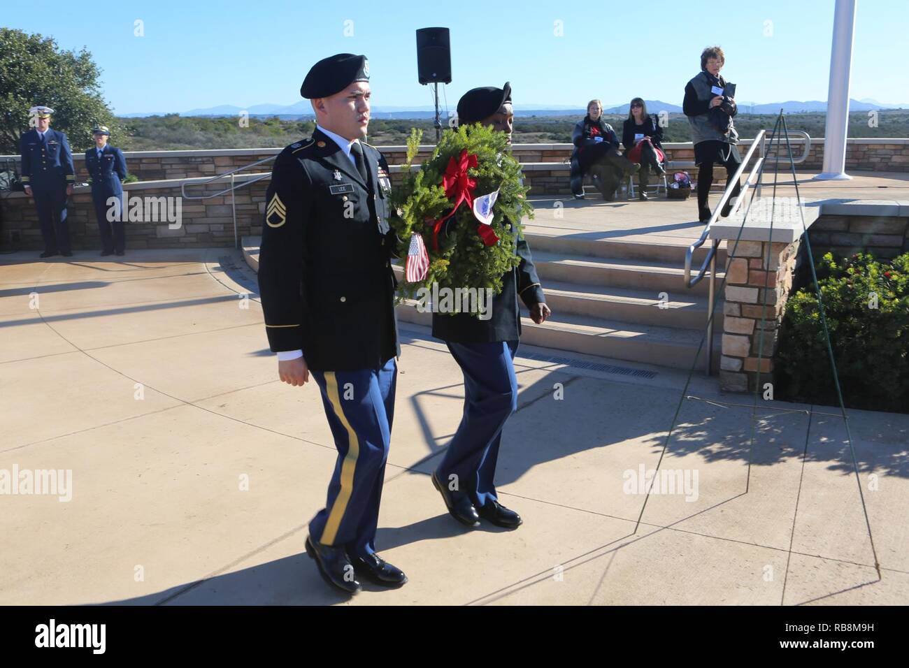 Service members participate in a wreath laying ceremony during the