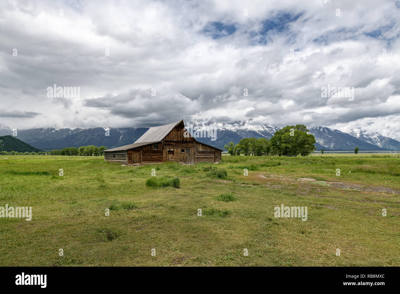 Old mormon barn in Grand Teton Mountains with low clouds. Grand Teton National Park, Wyoming, USA. Stock Photo
