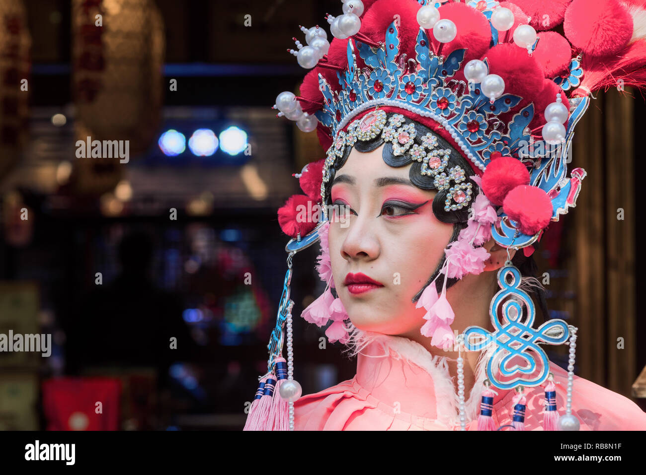 Chengdu, Sichuan Province, China - Nov 18, 2018 : Portrait of a yound woman dressed in Sichuan Opera traditional costume in Jinli street touristic area. Stock Photo